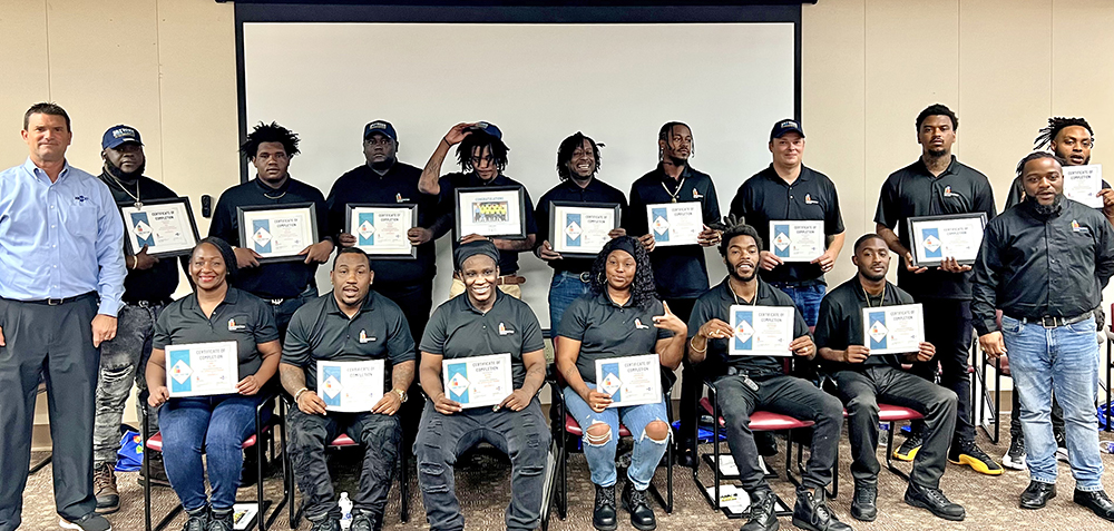 Group of graduating students downtown with their certificates of completion for Construction Ready class 3.
