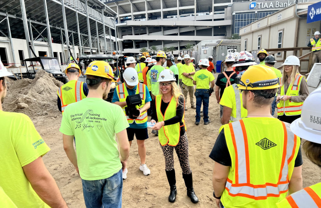 Jaguars staff handing out 350+ Amazon gift cards to site workers at Miller Electric Center.